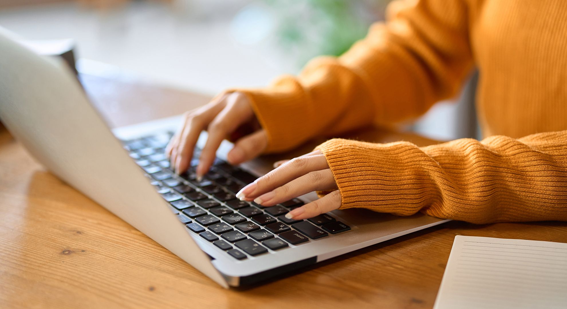 An asian woman's hand typing on a computer